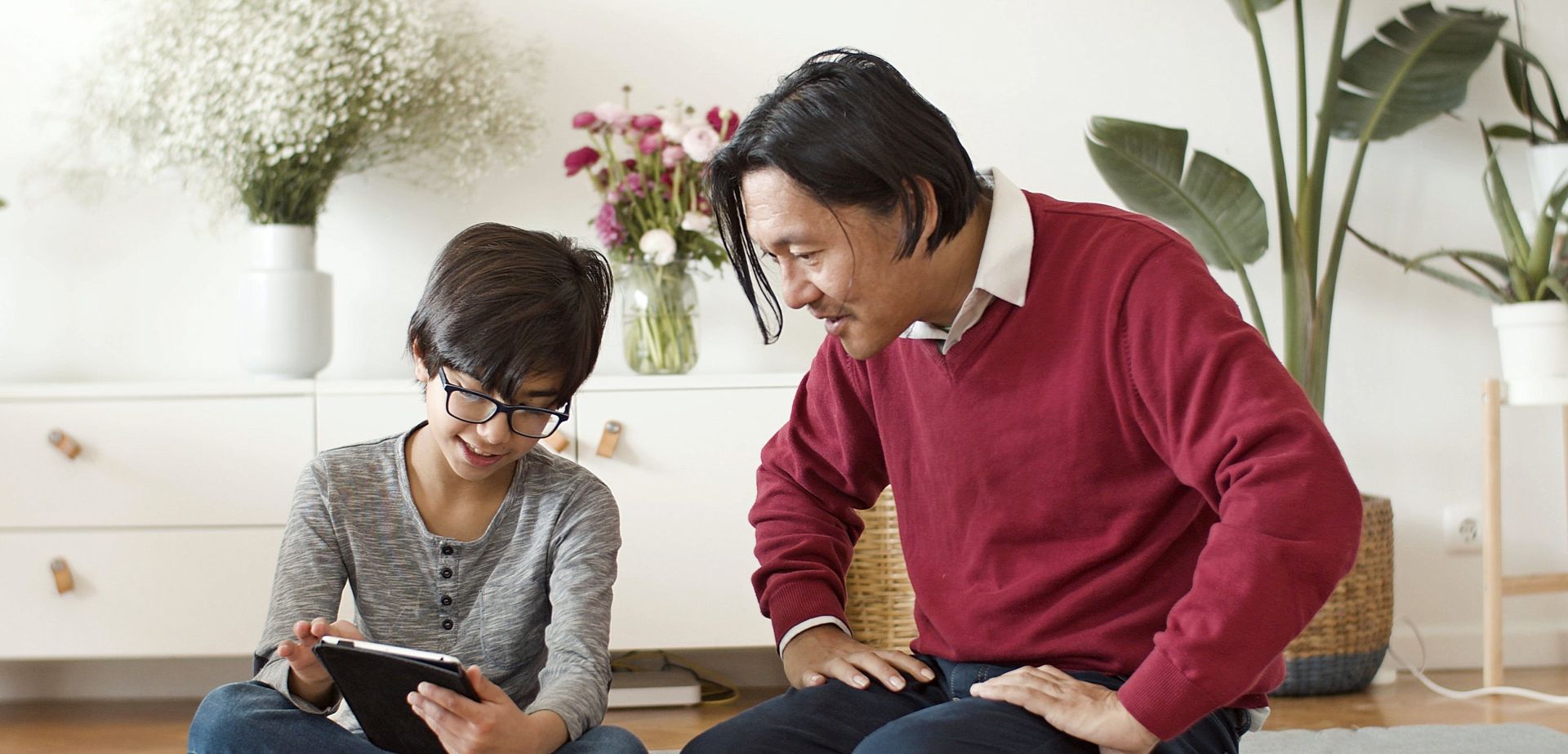 A Man and Kid Browsing the Internet on Digital Tablet